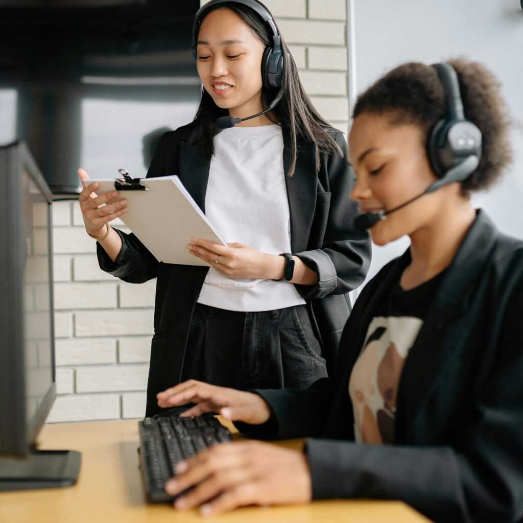 A Woman Standing Beside an Agent Looking at a Clipboard